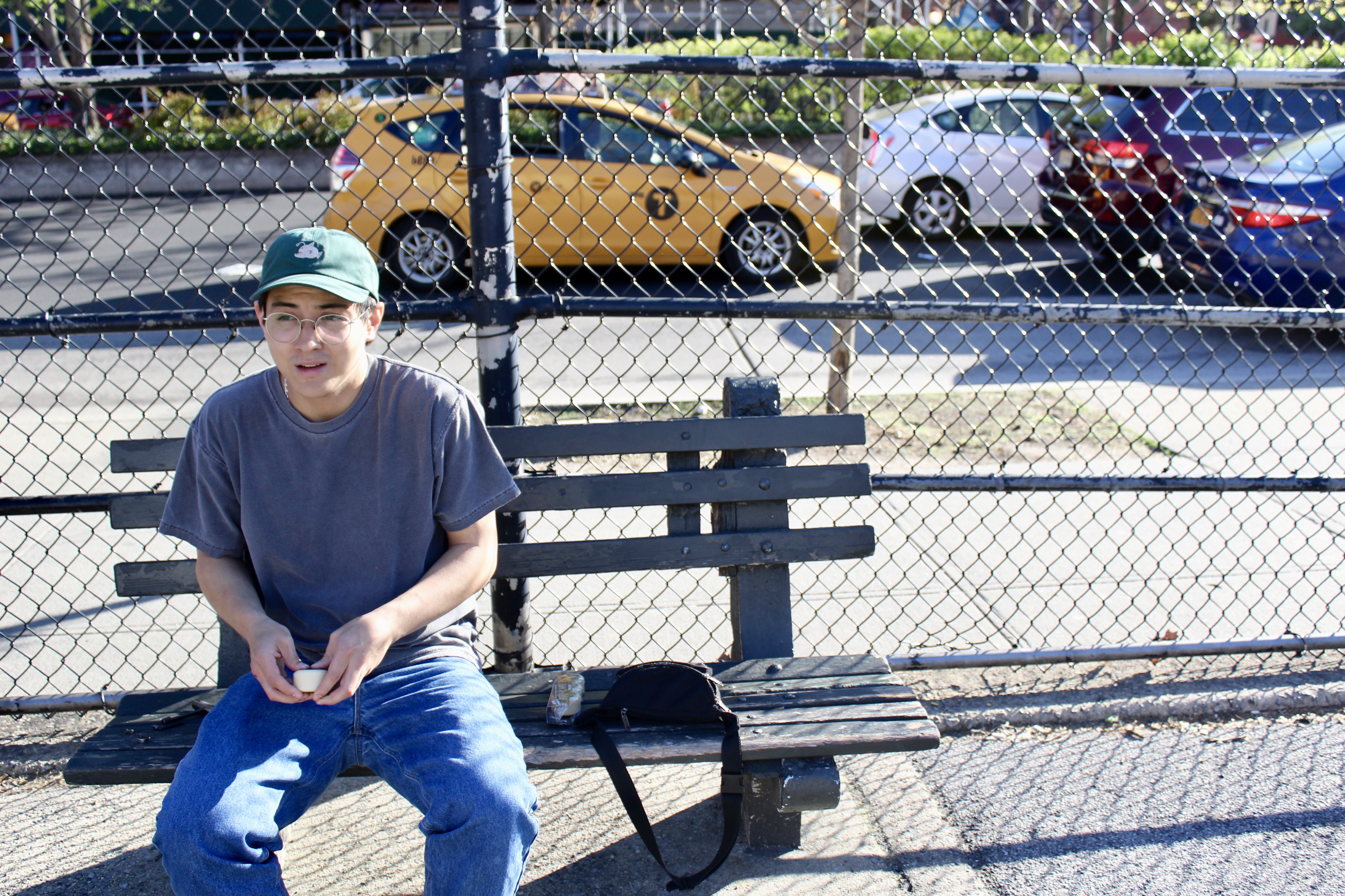 Bread sitting down at a bench in a park