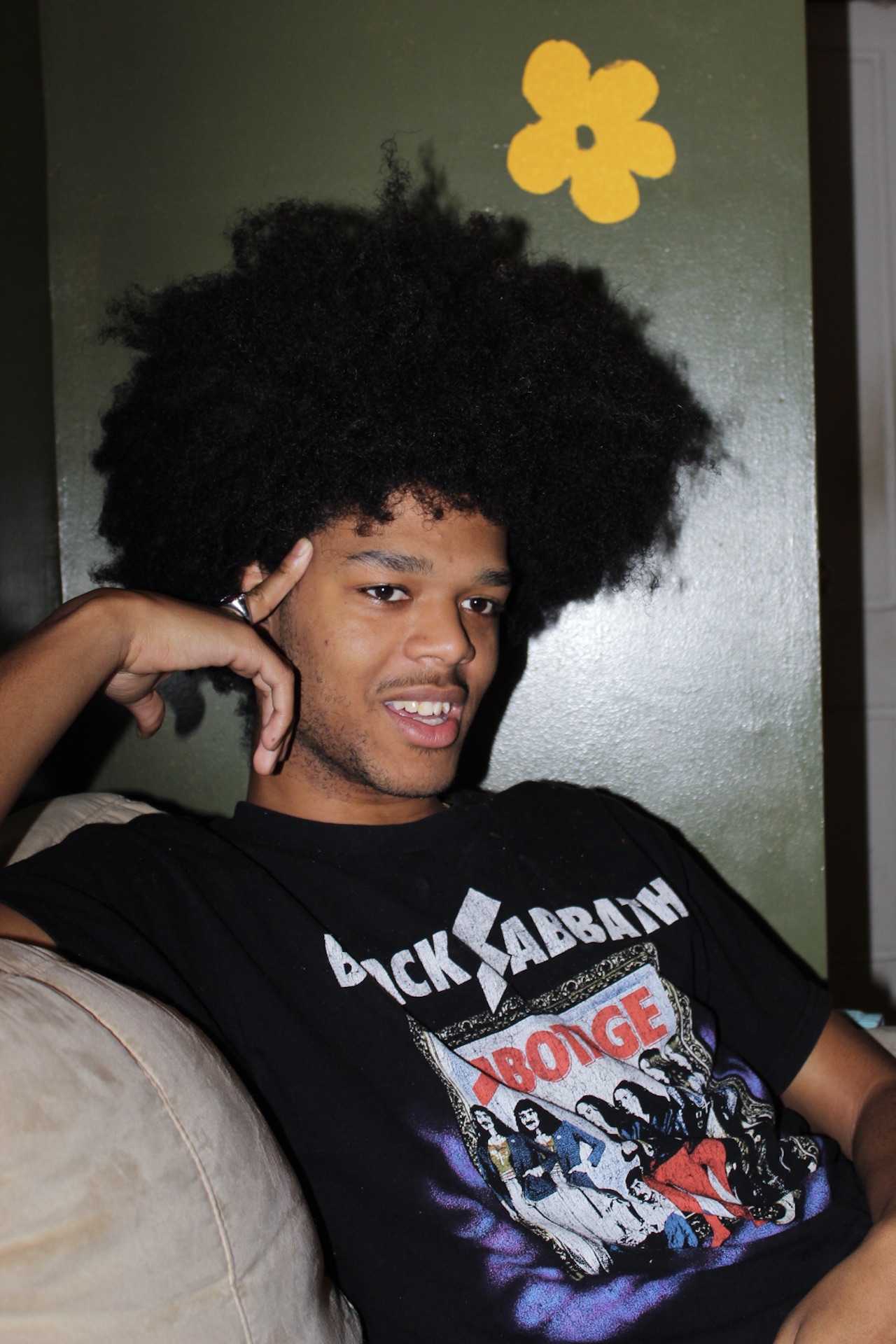 portrait of chris looking towards his left with his right hand on his temple