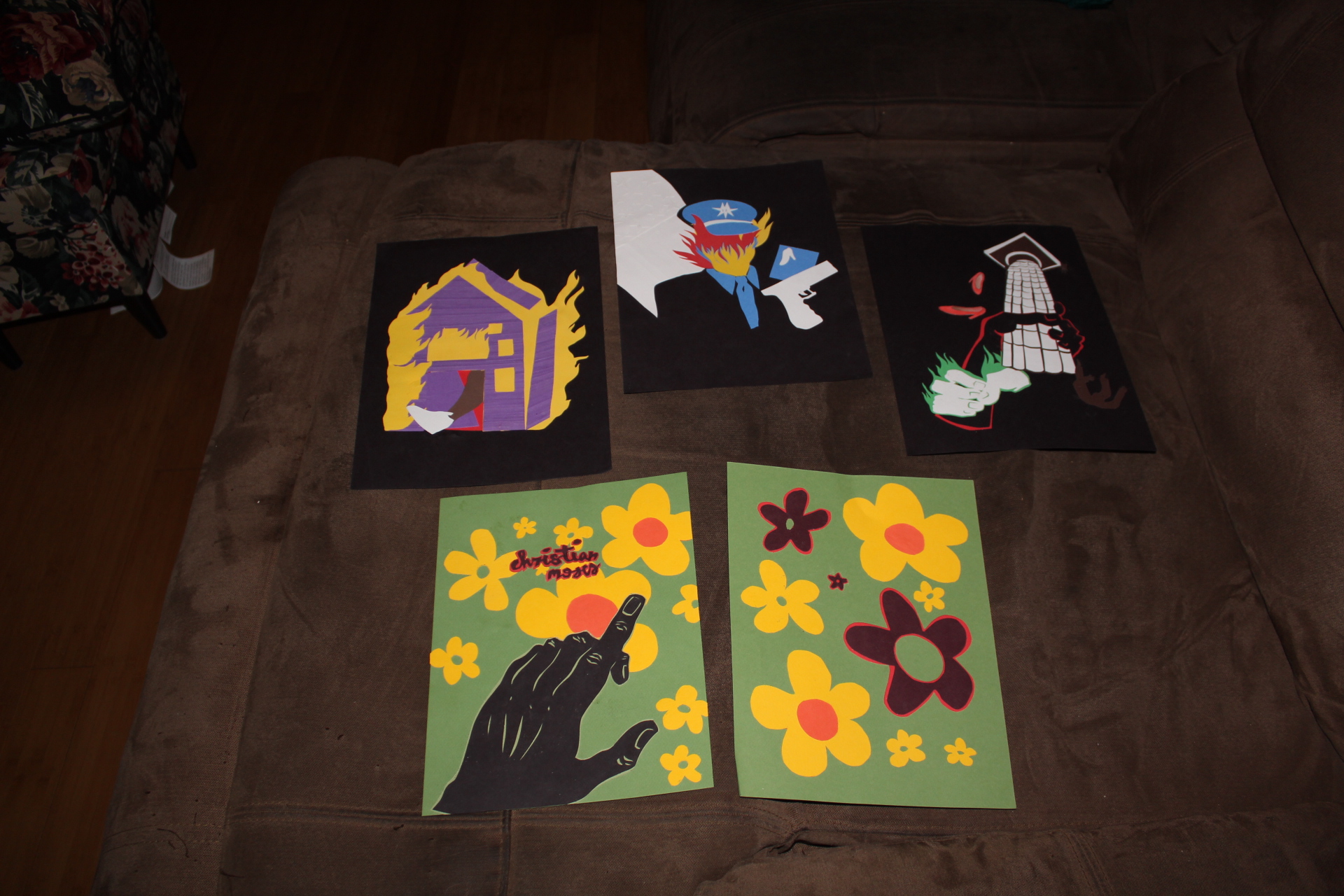 Collages made from paper layed out on couch